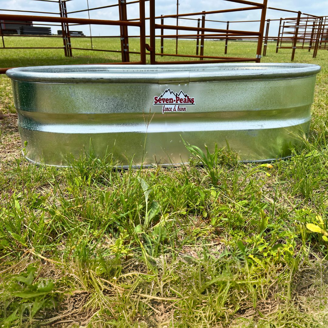 Oval Stock Tank on Pasture in Front of Fencing