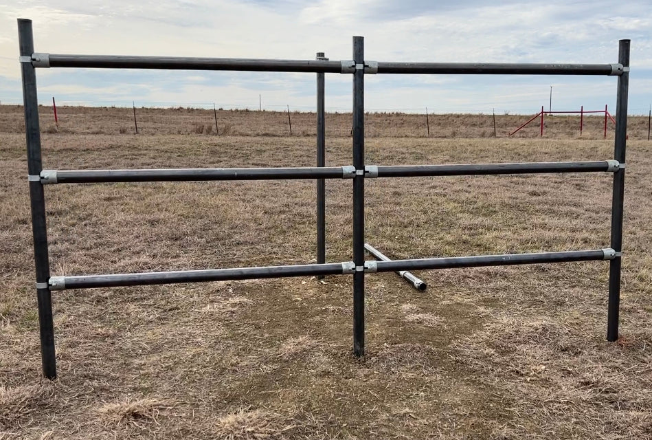 steel pipe fencing in a field