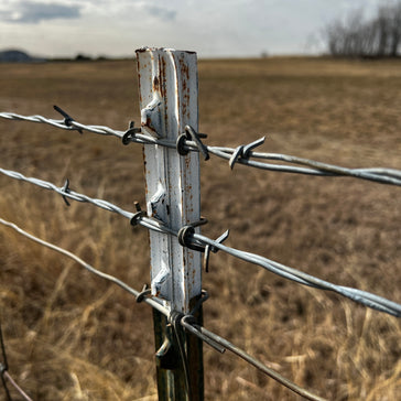 barbed wire fence post countryside field